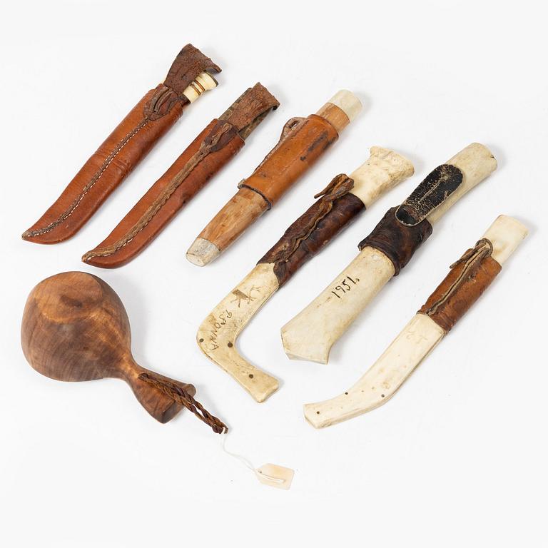 Six knives, and a cup.