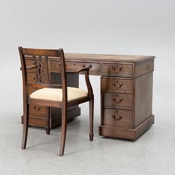 A mahogany and mahogany veneer desk with desk chair, 20th Century.