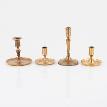 Four brass candlesticks, 18th-19th Century.