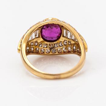 An 18K gold ring with baguette and brilliant cut diamonds and a ruby.