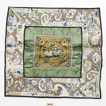 Three Chinese lacquer and wooden panels, two silk embroideries, first half of the 20th century.