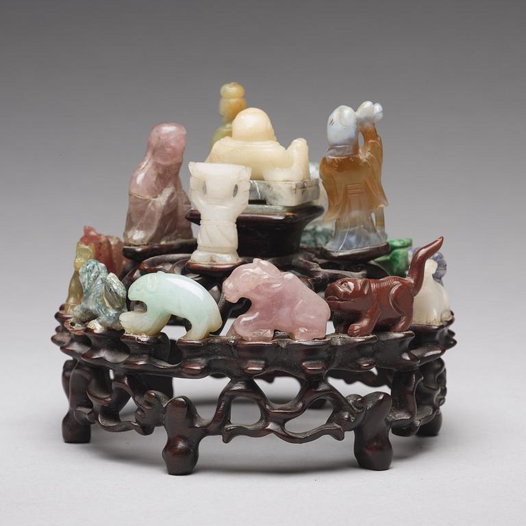 An arrangement of stone sculptures on a wooden stand, China 20th Century.