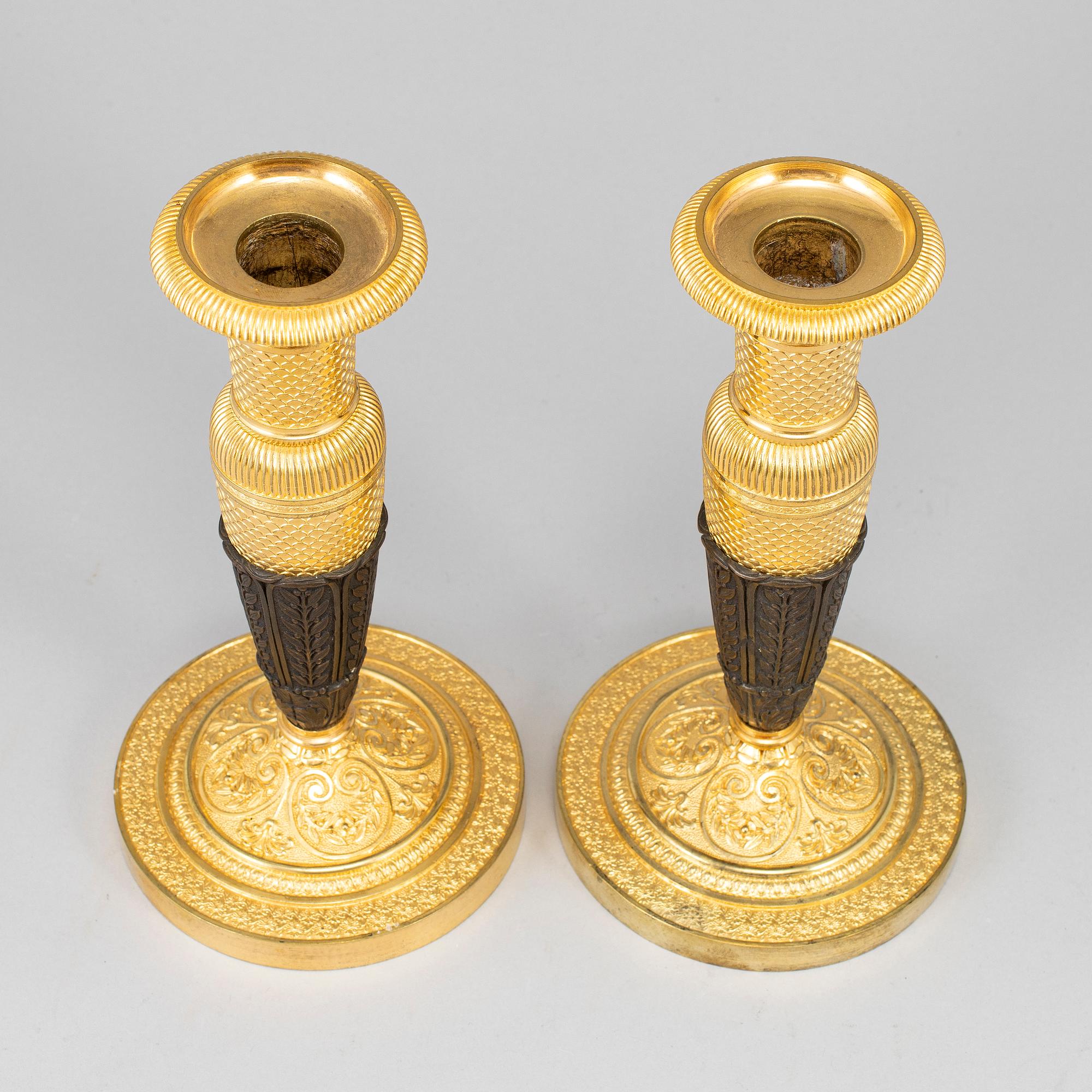 A pair of empire, ormolu candlesticks, first half of the 19th century.