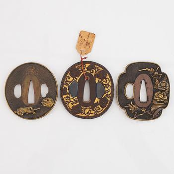 Five tsubas, 18/19th Century, one signed.