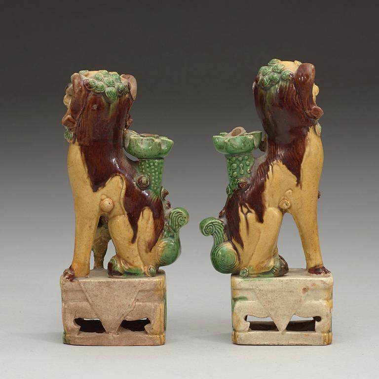 A pair of bisquit joss stick holders in the shape of buddhist lions, Qing dynasty, Kangxi (1662-1722).