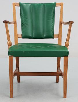 A Josef Frank mahogany and green leather armchair.
