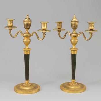 A pair of French Directoire late 18th century ormolu candelabra for three candles.