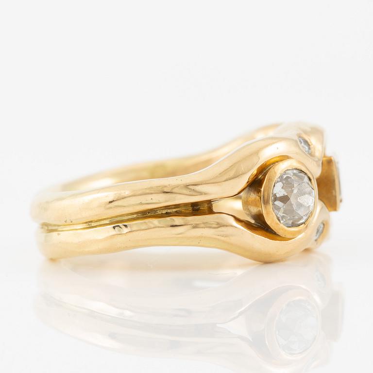 Ring in 18K gold set with old-cut diamonds and a faceted yellow sapphire.