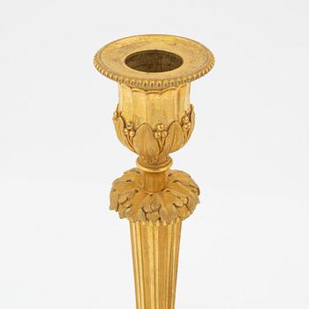 A pair of gilded bronze candelsticks, 19th Century.