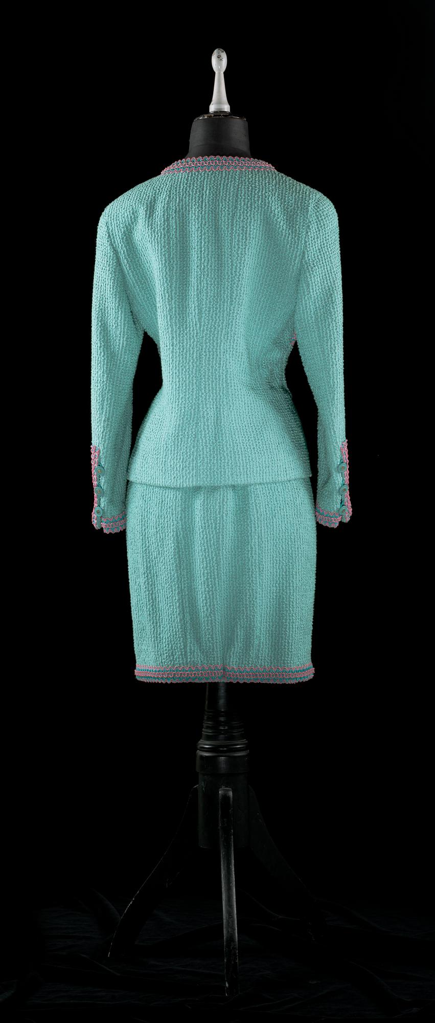 A 21 th cent green bouclé two-pieces costume by Chanel.