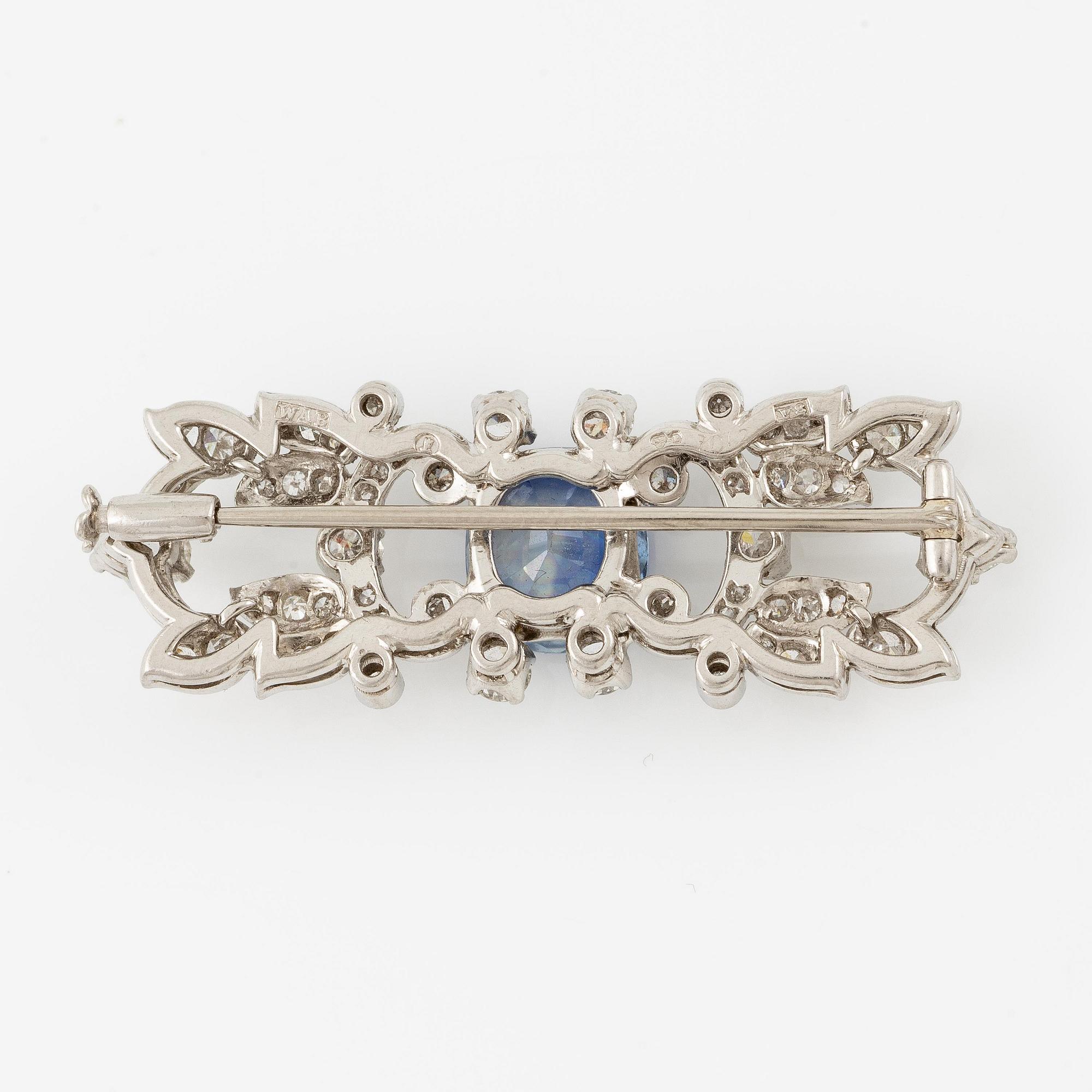 A W.A. Bolin brooch in platinum with a faceted sapphire.