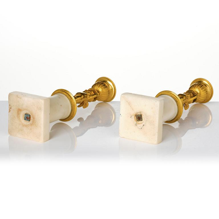 A pair of late Gustavian white marble and ormula candlesticks.