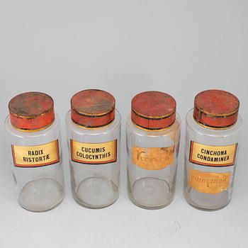 Four glas apothecary jars with metal lids, early 20th century.