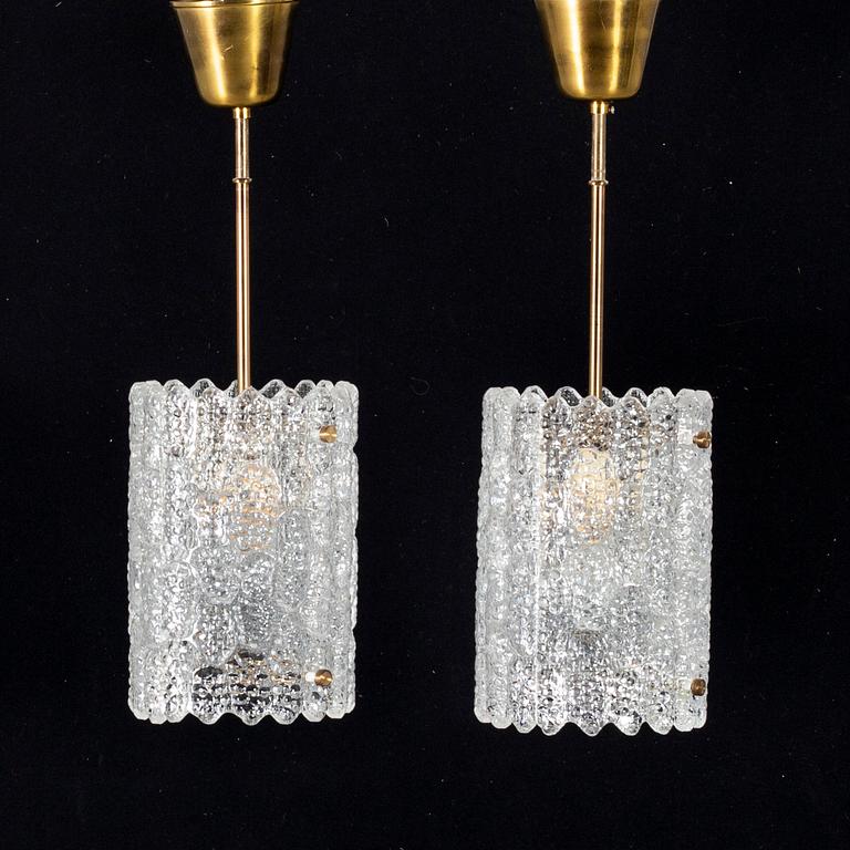 A pair of 20th century brass and glass ceiling lamps by Carl Fagerlund for Orrefors.