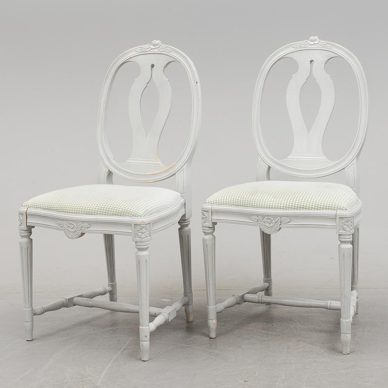 A Gustavian style dining table and ten chairs, 20th century.