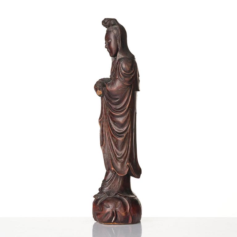 A wooden sculpture of Guanyin with metal inlay, Qing dynasty.