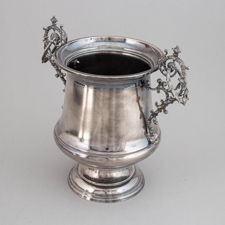 A silver plated winecooler.