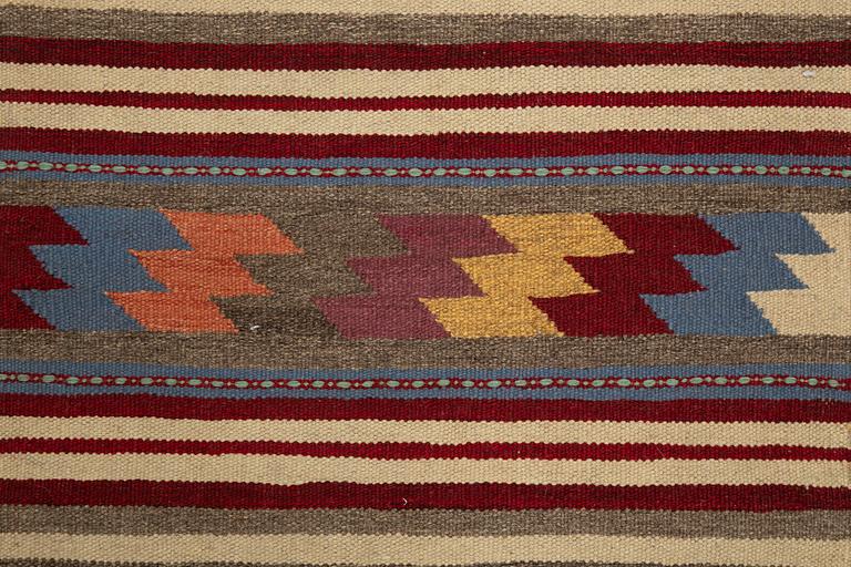 A persian kilim runner, c 246 x 64 cm.