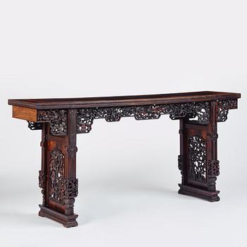 A massive zitan recessed-leg long table 'Jiaotousun Qiotouan', Qing dynasty, 19th century.