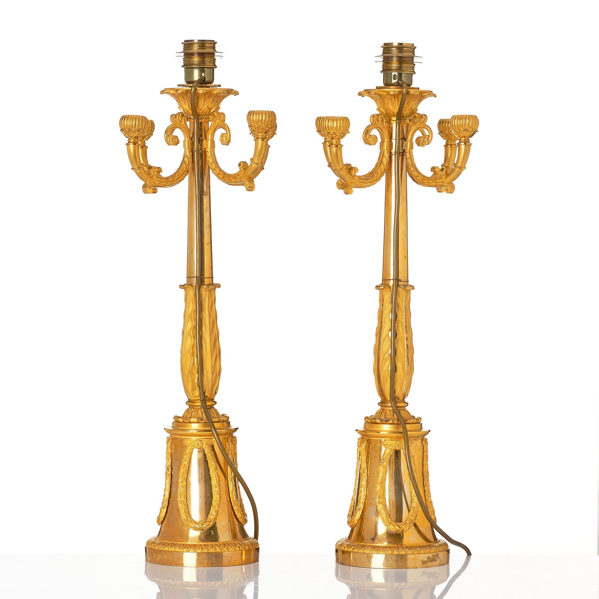 A pair of French Empire four-light candelabra (lamps), early 19th century.