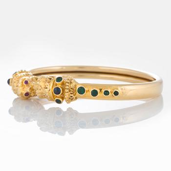 An Ilias Lalaounis bracelet in 18K gold set with emeralds, sapphires and rubies.