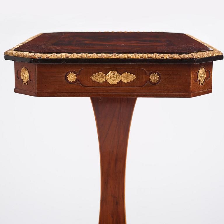 A north european Empire  'Umdruck'-decorated mahogny and gilded metal table.