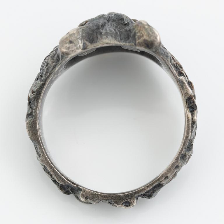 Ring in the form of an owl, silver with orange stone.