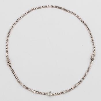 An 18K white gold necklace/bracelet combination set with round brilliant-cut diamonds.
