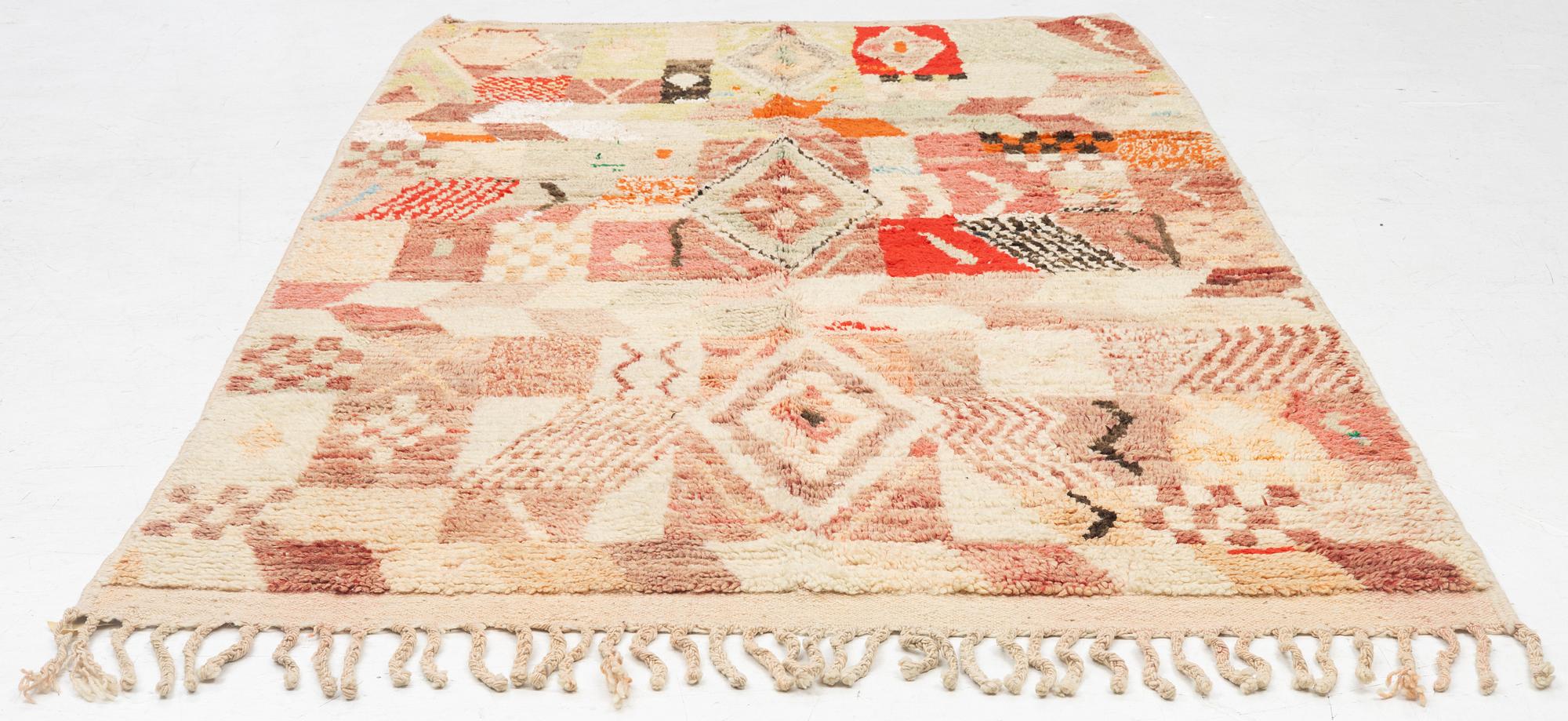 A Moroccan crpet, c. 240 (+7+8 cm flat weave) x 151 cm.