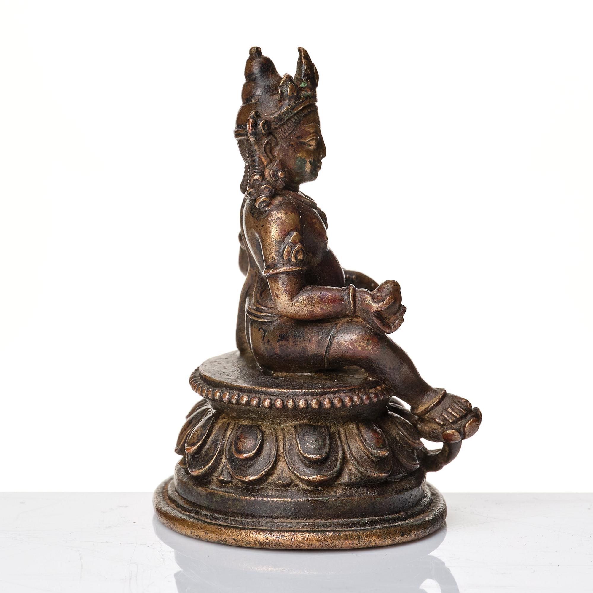 A copper alloy figure of Jambhala, Nepal, possibly 12/13th Century.