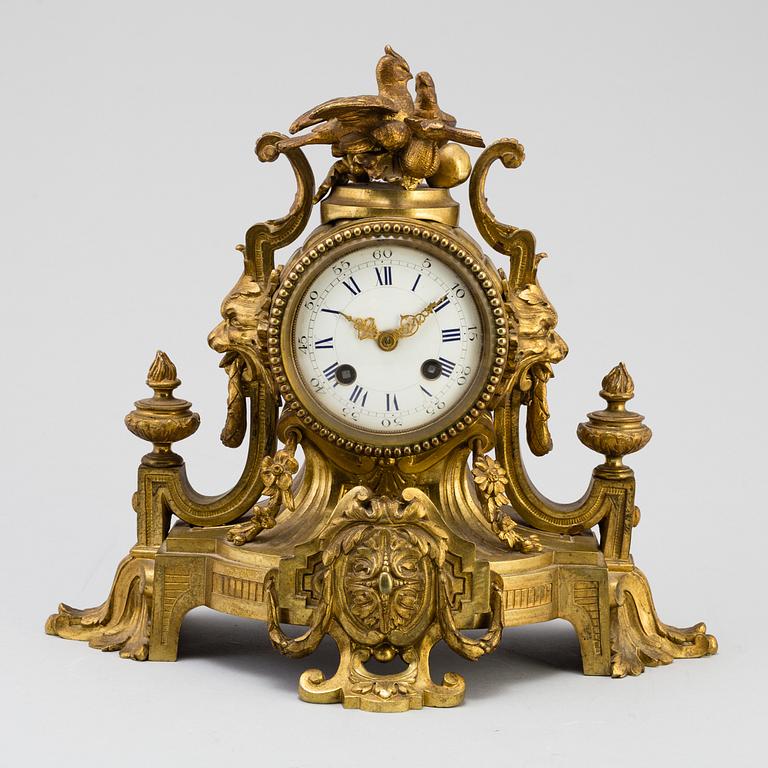 A table CLOCK and a pair of candelabra, second part of 19th century.