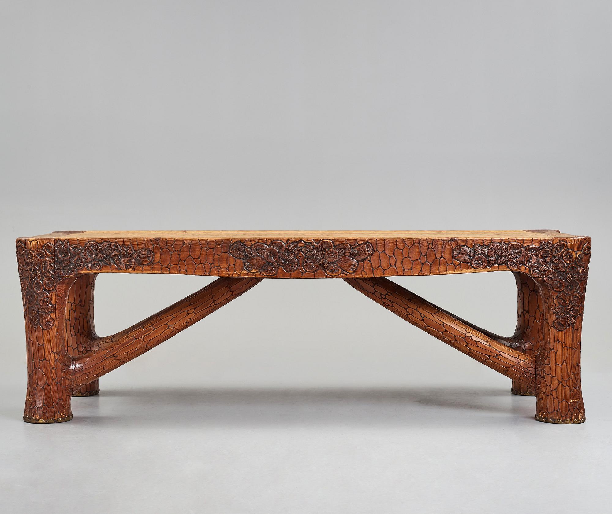Gustaf Fjaestad, an Art Nouveau carved pine table, Arvika Sweden 1914, a double to the table in the Thiel Collection,
