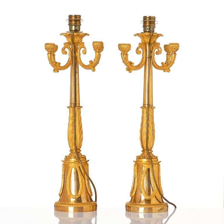 A pair of French Empire four-light candelabra (lamps), early 19th century.