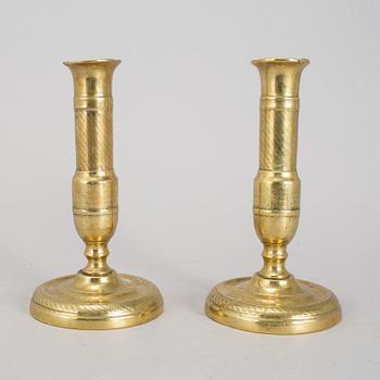 A 19th Century pair of brass candlesticks.