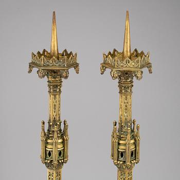 A pair of Pugin style gothic revival candlesticks, mid 19th century.