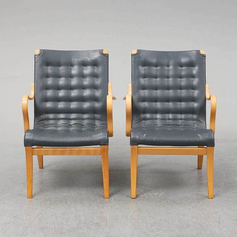 A second half of the 20th Century pair of 'Mina' armchairis by Bruno Mathsson for Mathsson International.