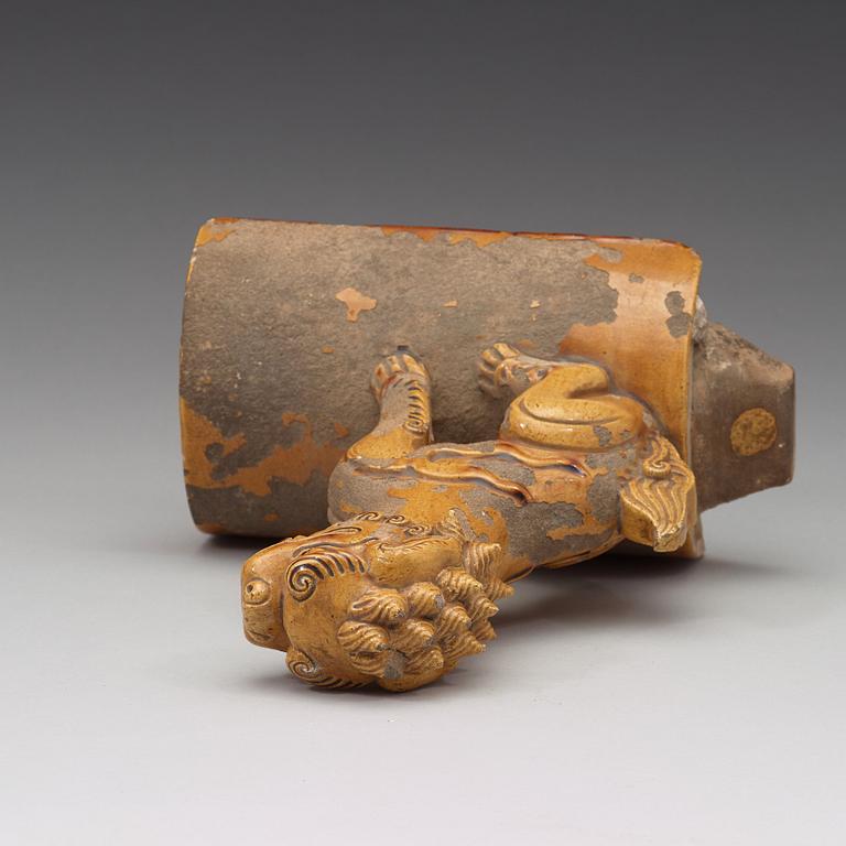 A yellow glazed roof tile figure of a Buddhist lion, Ming dynasty (1368-1644).