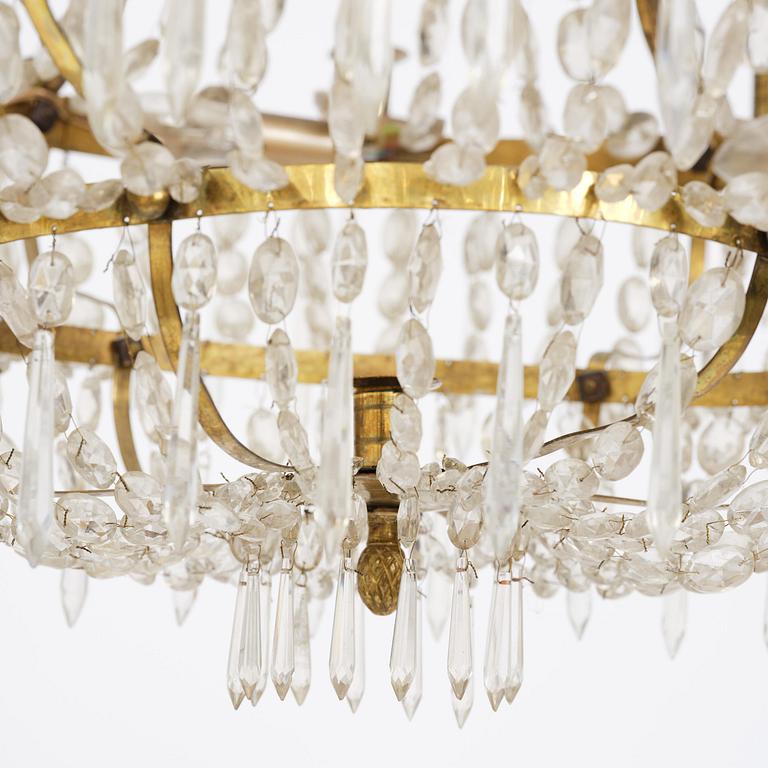 A Swedish gilt brass and cut glass thirteen-light Empire chandelier, early 19th century.