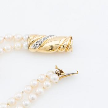 Necklace, two-stranded of cultured pearls with a clasp of 18K gold set with brilliant-cut diamonds, Damini Asolo Italy.