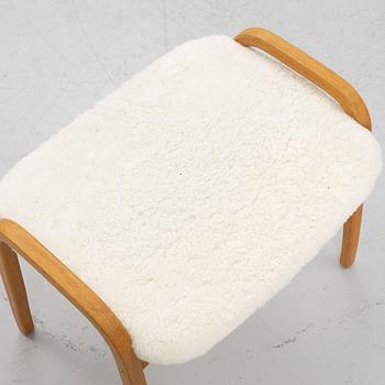 Yngve Ekström, a 'Lamino' armchair and a foot stool, Swedese.