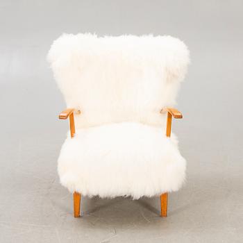 A 1940s sheepskin armchair.