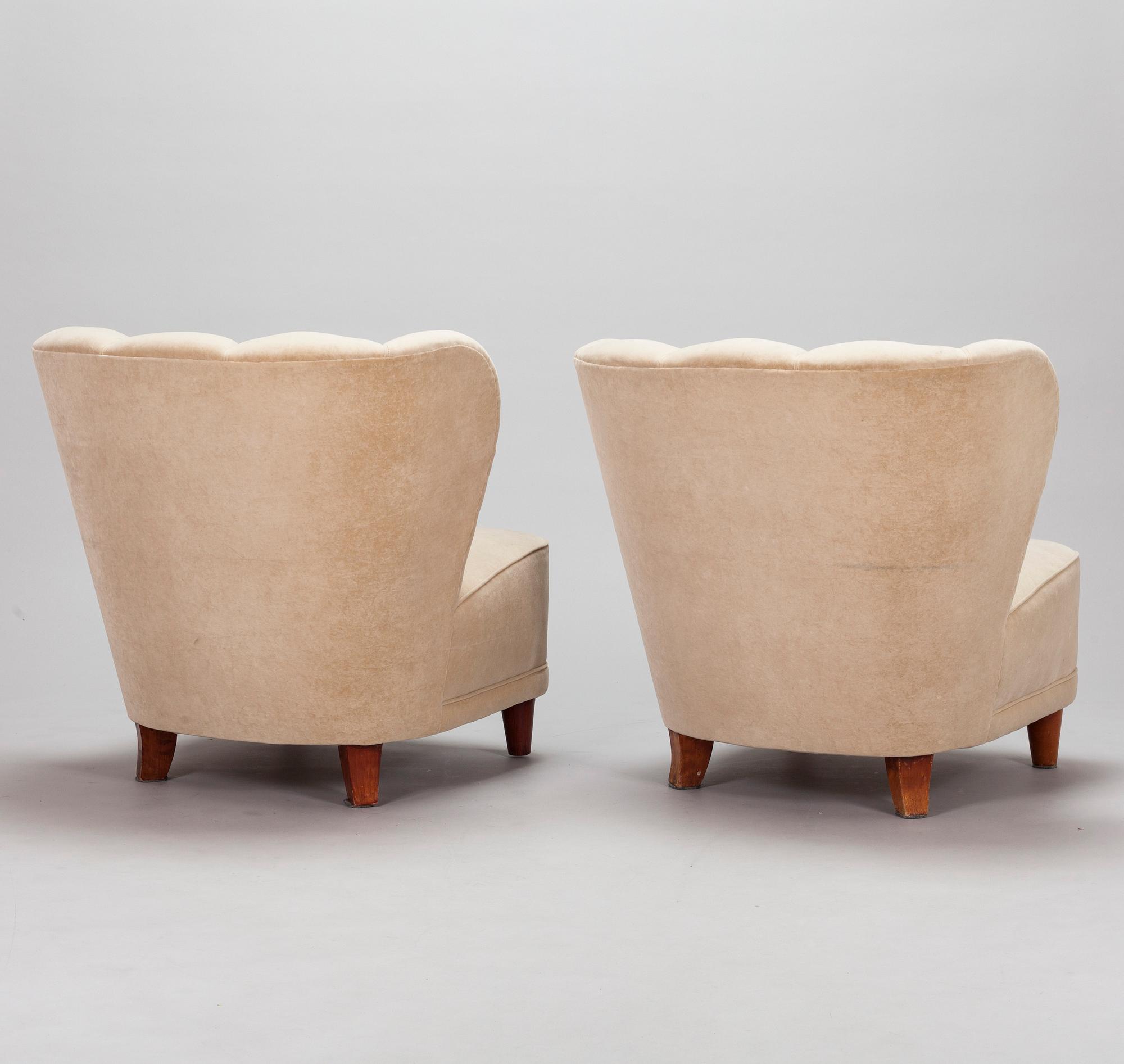 A pair of mid-20th century armchairs.