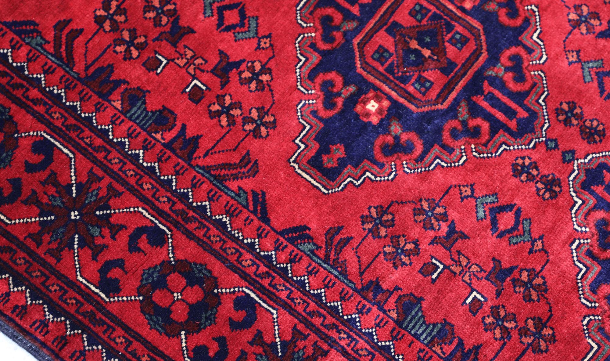 An Afghan runner, approximately 283 x 87 cm.