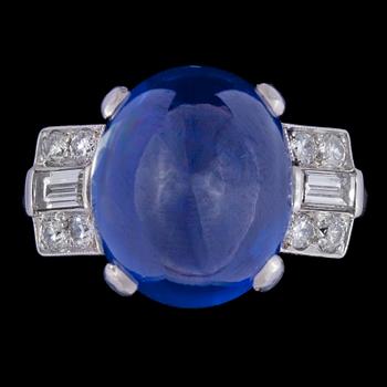 A cabochon cut blue Ceylon sapphire, 12.88 cts, and diamond ring, 1930's.