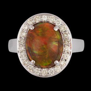 1387. A cabochon cut opal, 3.25 cts, and brilliant cut diamond ring, tot. 0.53 cts.