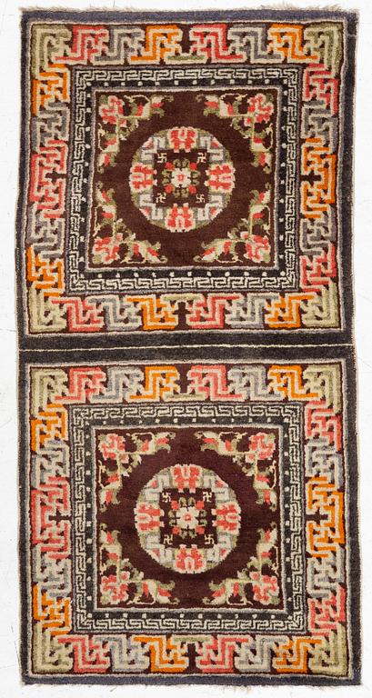 A Chinese two square rug, antique, c. 142 x 71 cm.