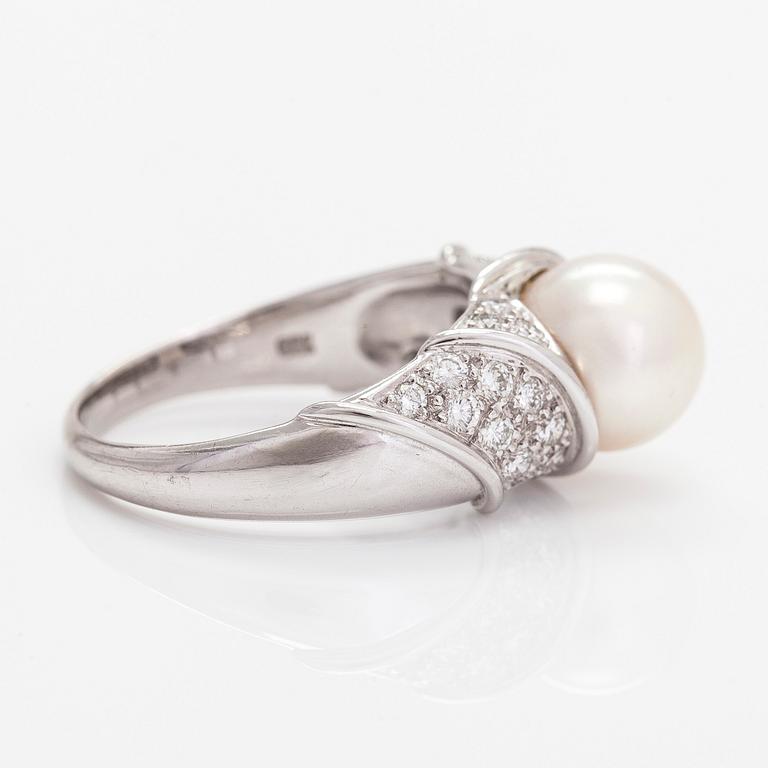 An 18K white gold ring, with a cultured pearl and diamonds totalling approximately 0.70 ct.