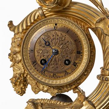 A presumably French Empire-style gilt bronze and marble mantel clock, later part 19th century.