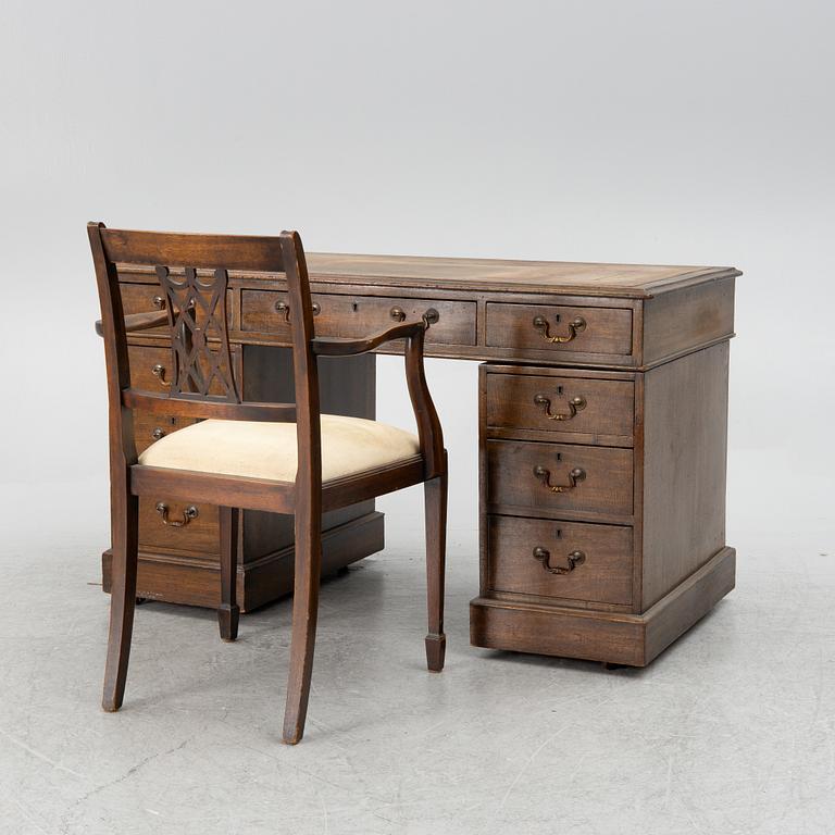 A mahogany and mahogany veneer desk with desk chair, 20th Century.