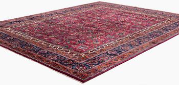 A Mashad carpet, signed Saber, c. 459 x 348 cm.